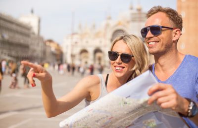 Tourists looking at city map in Venice